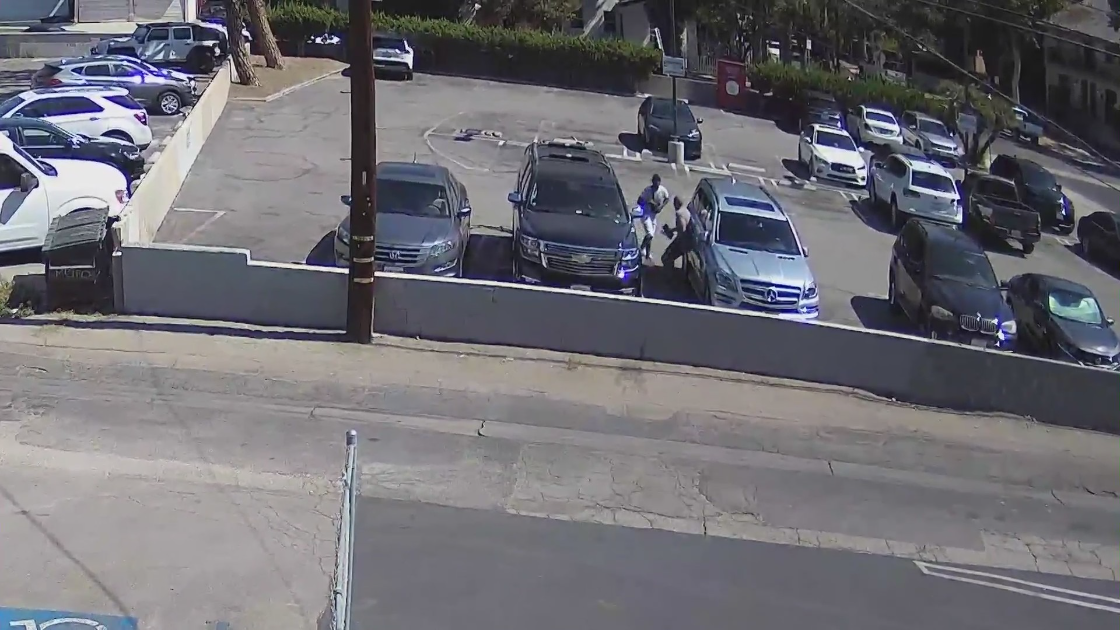 Surveillance video obtained by the victim shows him being robbed outside a Sherman Oaks bank on July 19, 2022.