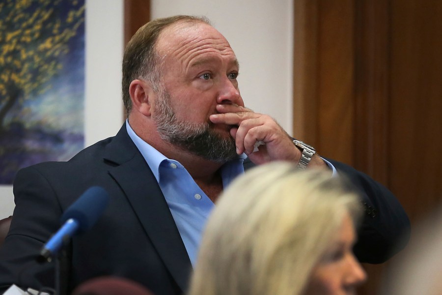 Alex Jones attempts to answer questions about his text messages asked by Mark Bankston, lawyer for Neil Heslin and Scarlett Lewis, during trial at the Travis County Courthouse in Austin on Aug. 3, 2022.(Briana Sanchez/Austin American-Statesman via AP, Pool)