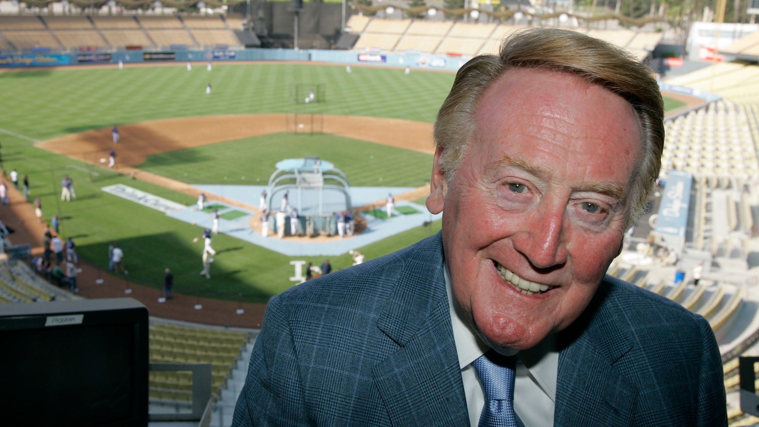 Los Angeles Dodgers broadcaster Vin Scully poses in the pressbox of Dodger Stadium before the start of a baseball game between the San Francisco Giants and the Dodgers on Aug. 1, 2007, in Los Angeles. (AP Photo/Mark J. Terrill, File)