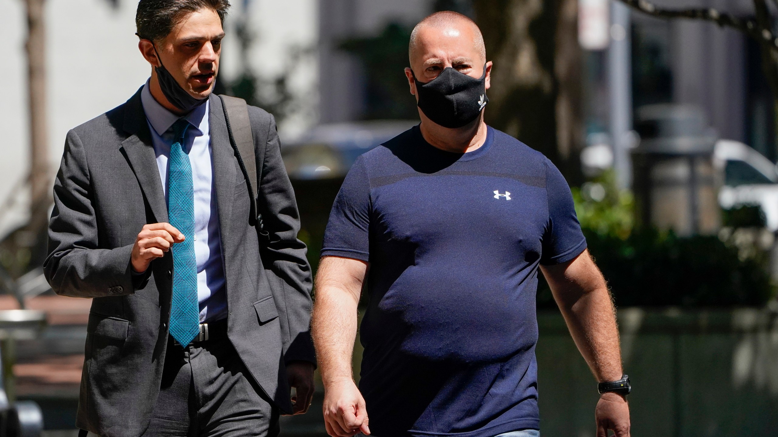 James Theodore Highhouse, right, arrives for his sentencing hearing at U.S. District Court with his attorney Jaime Dorenbaum, left, in Oakland, Calif., Wednesday, Aug. 31, 2022. Highhouse pleaded guilty to sexually abusing an inmate while working as a prison chaplain at a federal women's prison in Dublin, Calif. (AP Photo/Godofredo A. Vásquez)