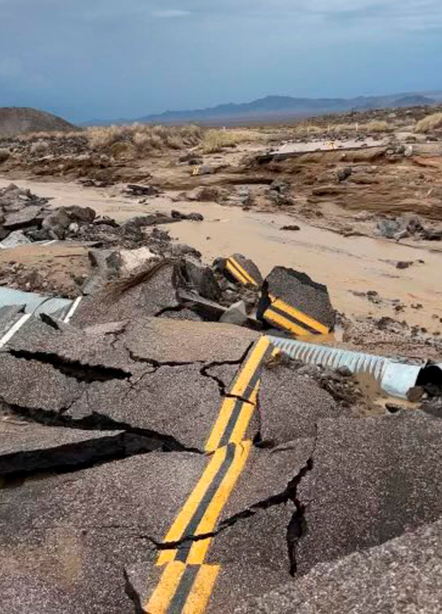 In this photo released by the National Park Service, is the damaged intersection of Kelbaker Road and Mojave Road in the Mojave National Preserve, Calif. on Sunday, July 31, 2022. (National Park Service via AP)