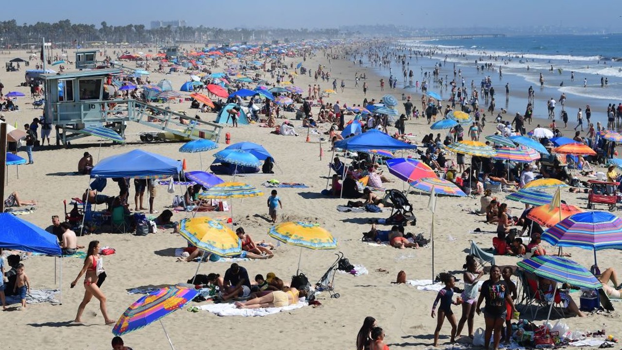 Beachgoers lying in the sand at Santa Monica Beach, California