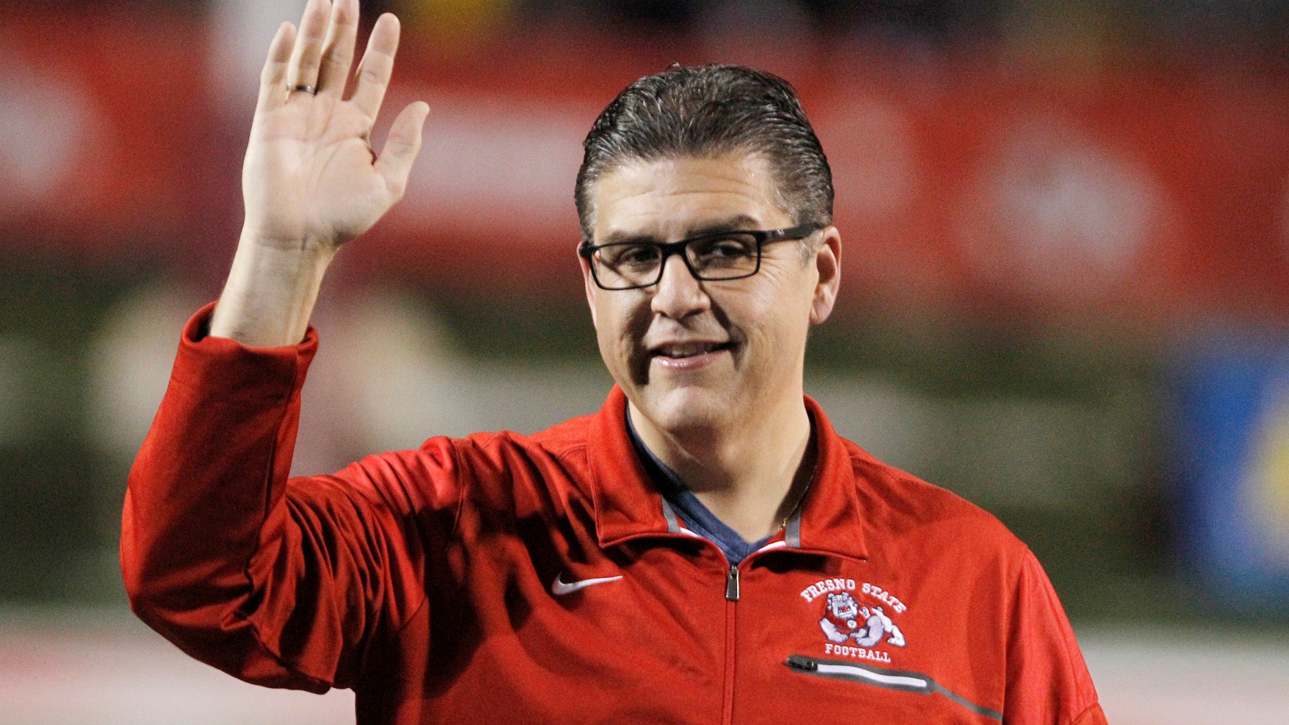 Joseph I. Castro, at the time president of Fresno State, waves to the crowd before the team's NCAA college football game Nov. 4, 2017, against BYU in Fresno, Calif. Castro mishandled sexual misconduct allegations while he headed the Fresno campus, according to a report released Thursday, Sept. 29, 2022. Castro failed to deal properly with complaints against Frank Lamas while Castro was Fresno State's president because he had a “blind spot” for his friend, according to the results of a months-long investigation commissioned by the California State University system. (AP Photo/Gary Kazanjian, File)