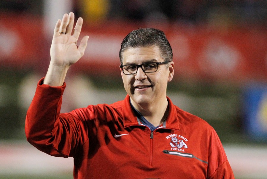 Joseph I. Castro, at the time president of Fresno State, waves to the crowd before the team's NCAA college football game Nov. 4, 2017, against BYU in Fresno, Calif. Castro mishandled sexual misconduct allegations while he headed the Fresno campus, according to a report released Thursday, Sept. 29, 2022. Castro failed to deal properly with complaints against Frank Lamas while Castro was Fresno State's president because he had a “blind spot” for his friend, according to the results of a months-long investigation commissioned by the California State University system. (AP Photo/Gary Kazanjian, File)