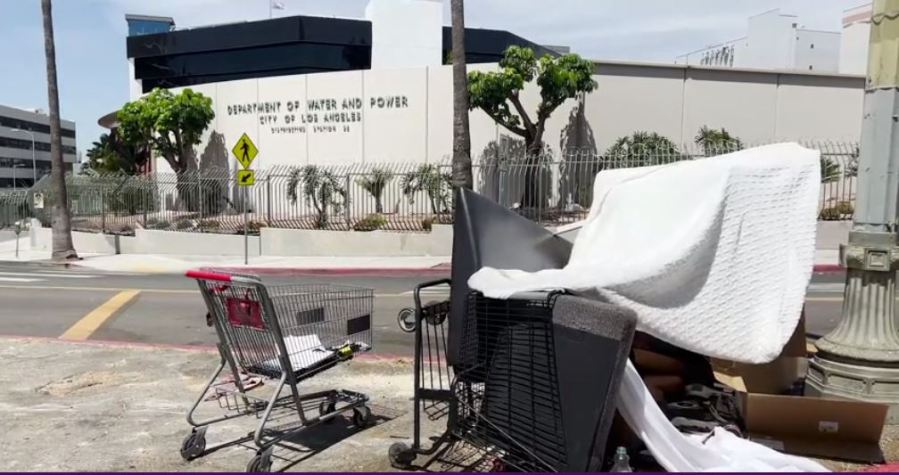 A person's belongings piled up across of the Department of Water and Power building in Los Angeles (KTLA)