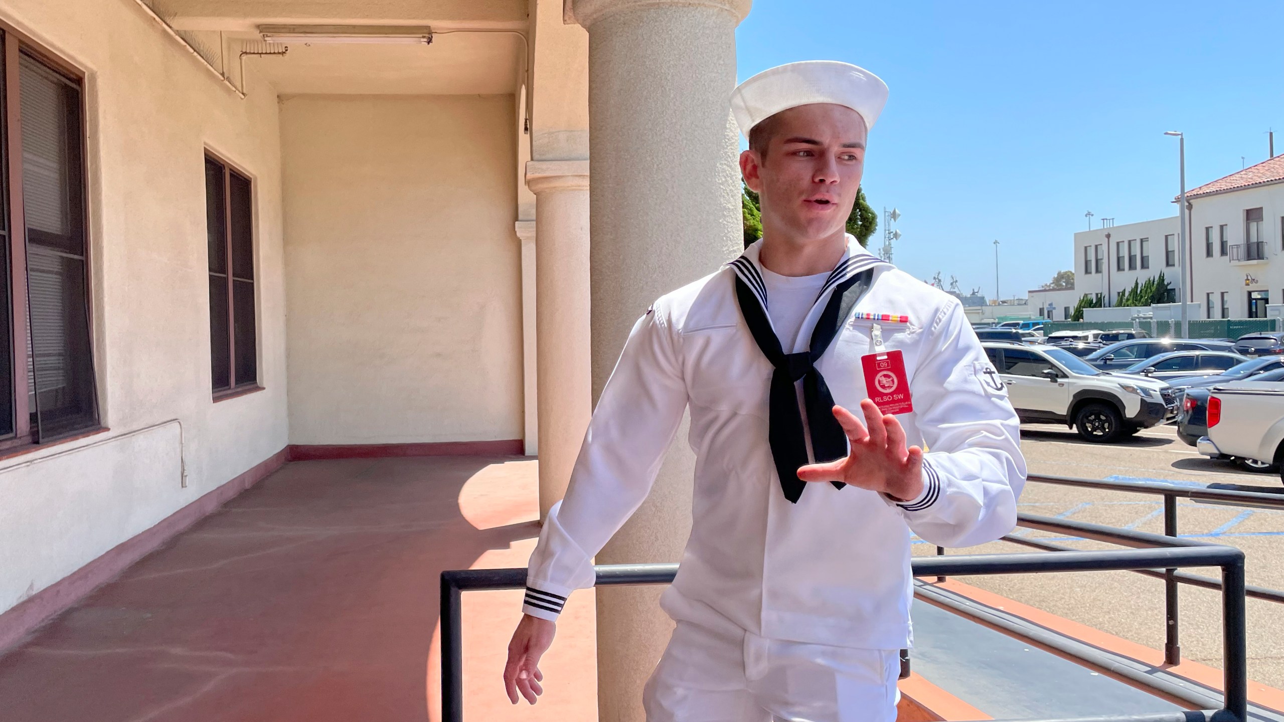 U.S. Navy sailor Ryan Sawyer Mays walks past reporters at Naval Base San Diego before entering a Navy courtroom Wednesday, Aug. 17, 2022, in San Diego. Mays is accused of setting the USS Bonhomme Richard on fire, and his court martial is scheduled to begin Monday, Sept. 19, 2022. The July 2020 blaze damaged the billion-dollar warship so badly it had to be scuttled and marked one of the worst noncombat US warship disasters in recent memory. (AP Photo/Julie Watson)