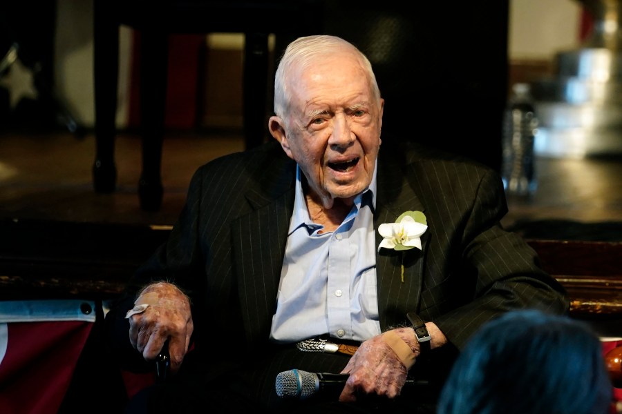 Former President Jimmy Carter reacts as his wife Rosalynn Carter speaks during a reception to celebrate their 75th wedding anniversary Saturday, July 10, 2021, in Plains, Ga.. (AP Photo/John Bazemore, Pool, File)