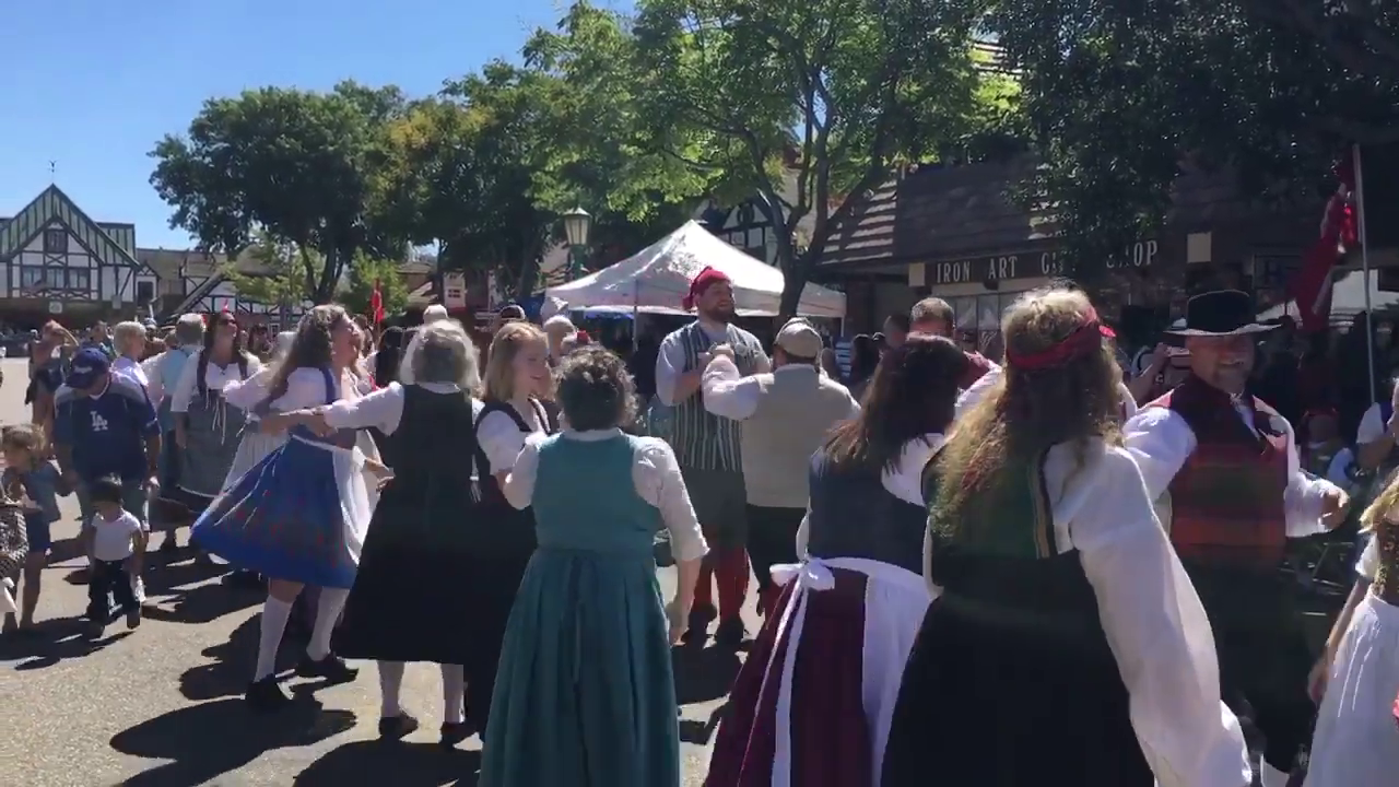 Street performers dance on Copenhagen Drive in downtown Solvang during Danish Days 2018 (KTLA)