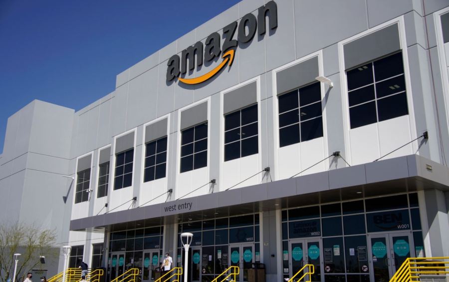 A worker walks out of an Amazon Fulfillment Center, (AP Photo/John Locher)