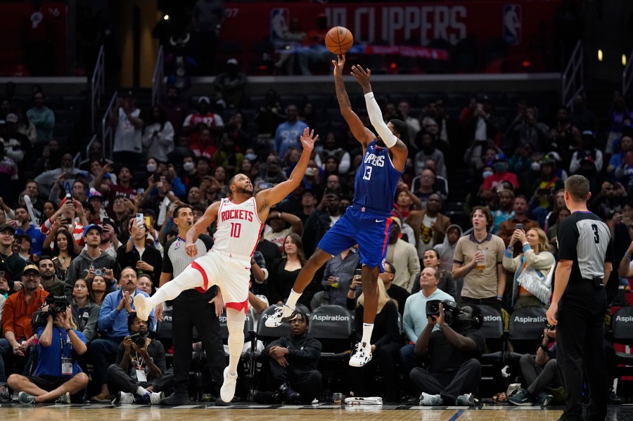 LA Clippers forward Paul George (13) shoots against Houston Rockets guard Eric Gordon (10) during the second half of an NBA basketball game in Los Angeles, Monday, Oct. 31, 2022. The Clippers won 95-93. (AP Photo/Ashley Landis)