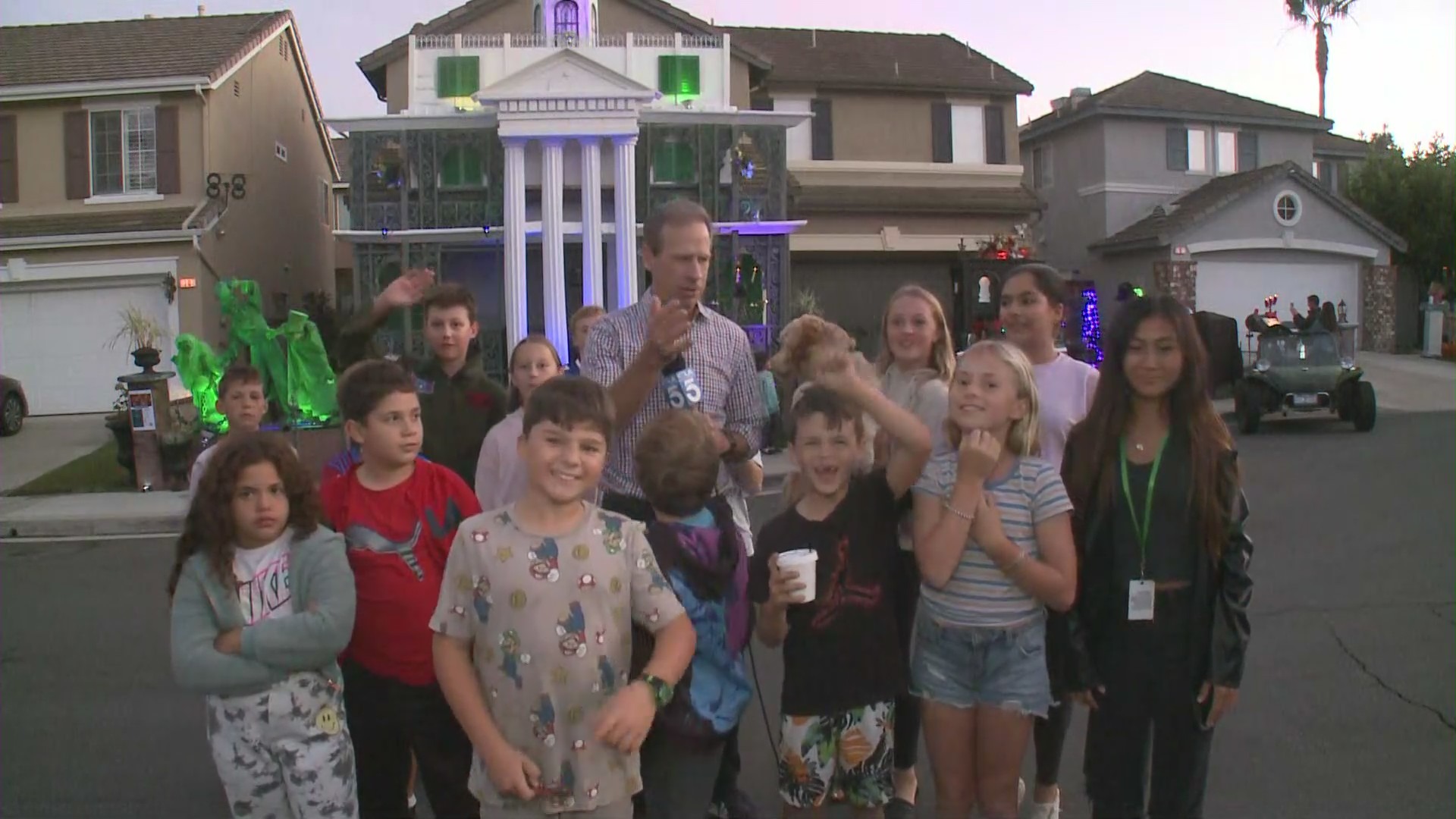 Chip Yost and a gang of Halloween fans gather outside the Stanley family's spooky season celebration on Oct. 28, 2022. (KTLA)