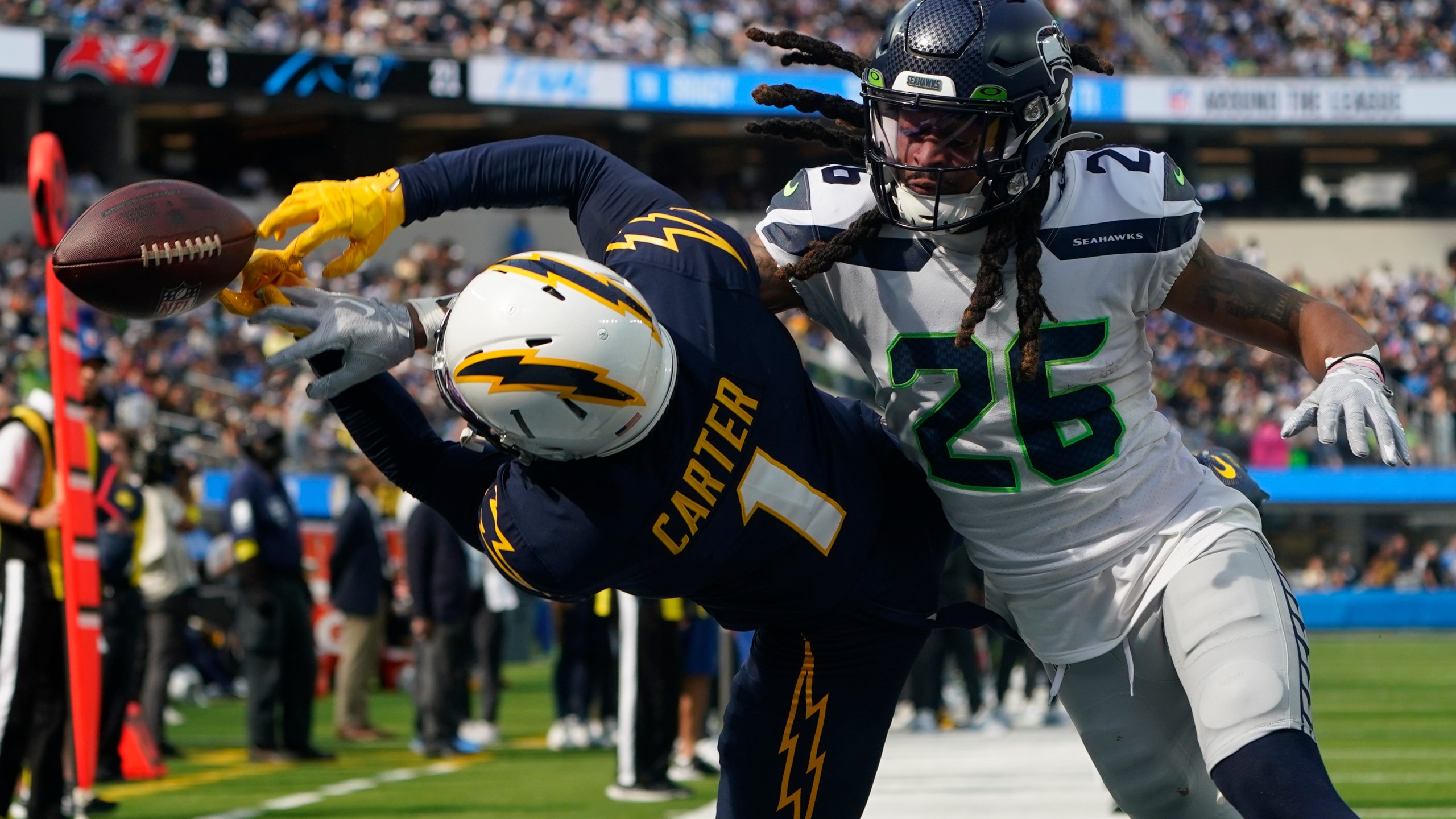 Seattle Seahawks safety Ryan Neal breaks up a pass intended for Los Angeles Chargers wide receiver DeAndre Carter in the end zone during the first half of an NFL football game Sunday, Oct. 23, 2022, in Inglewood. (AP Photo/Marcio Jose Sanchez)