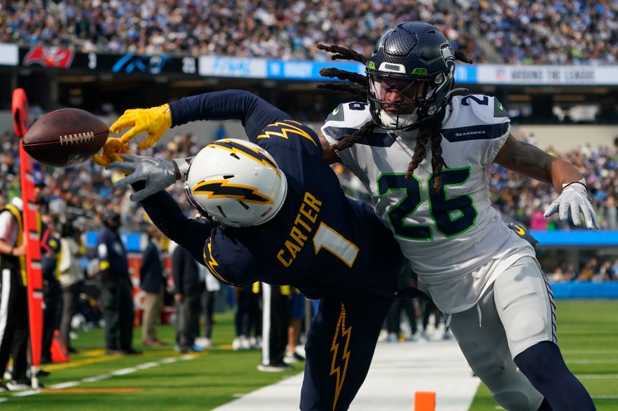 Seattle Seahawks safety Ryan Neal breaks up a pass intended for Los Angeles Chargers wide receiver DeAndre Carter in the end zone during the first half of an NFL football game Sunday, Oct. 23, 2022, in Inglewood. (AP Photo/Marcio Jose Sanchez)