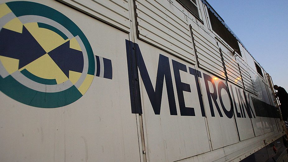 A conductor steps down from the engine of a Metrolink train in Chatsworth.