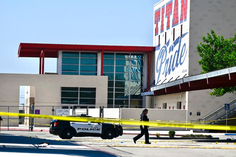 A police officer marks the scene of a shooting in Ontario, Calif., on Saturday, Oct. 1, 2022, after a person was shot several times at a youth football game at Colony High School. The game was not a school-sponsored event. (Watchara Phomicinda/The Orange County Register via AP)