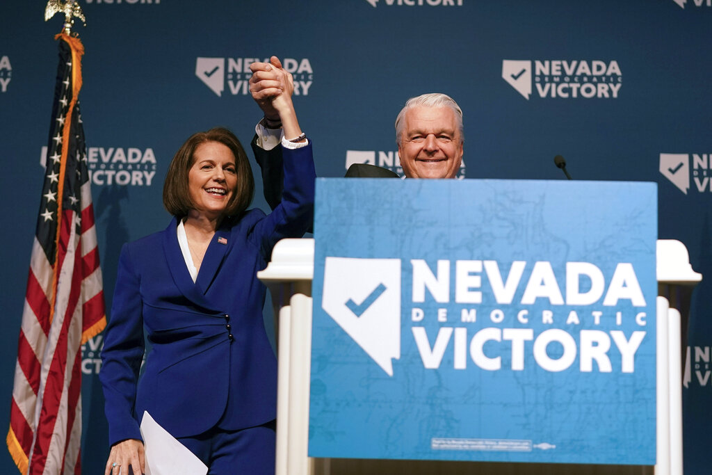 Sen. Catherine Cortez Masto, D-Nev., left, reacts alongside Nevada Gov. Steve Sisolak during an election night party hosted by the Nevada Democratic Party, Tuesday, Nov. 8, 2022, in Las Vegas. (AP Photo/Gregory Bull)