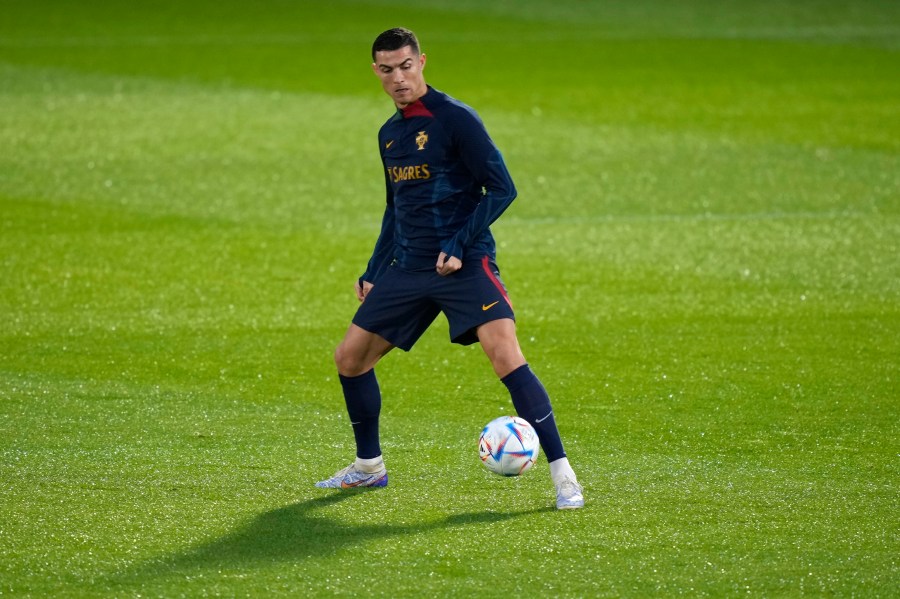 Cristiano Ronaldo plays with a ball during a Portugal soccer team training in Oeiras, outside Lisbon on Nov. 14, 2022. (Armando Franca/Associated Press)