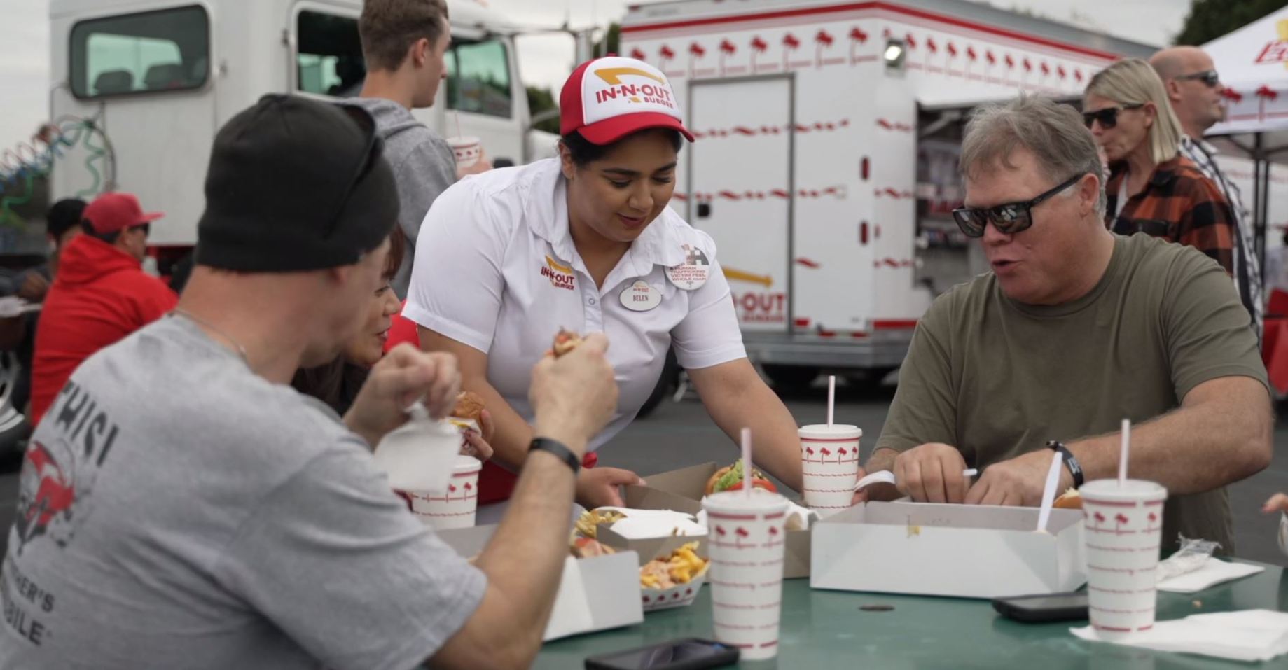 Burgers and fries being delivered to customers.