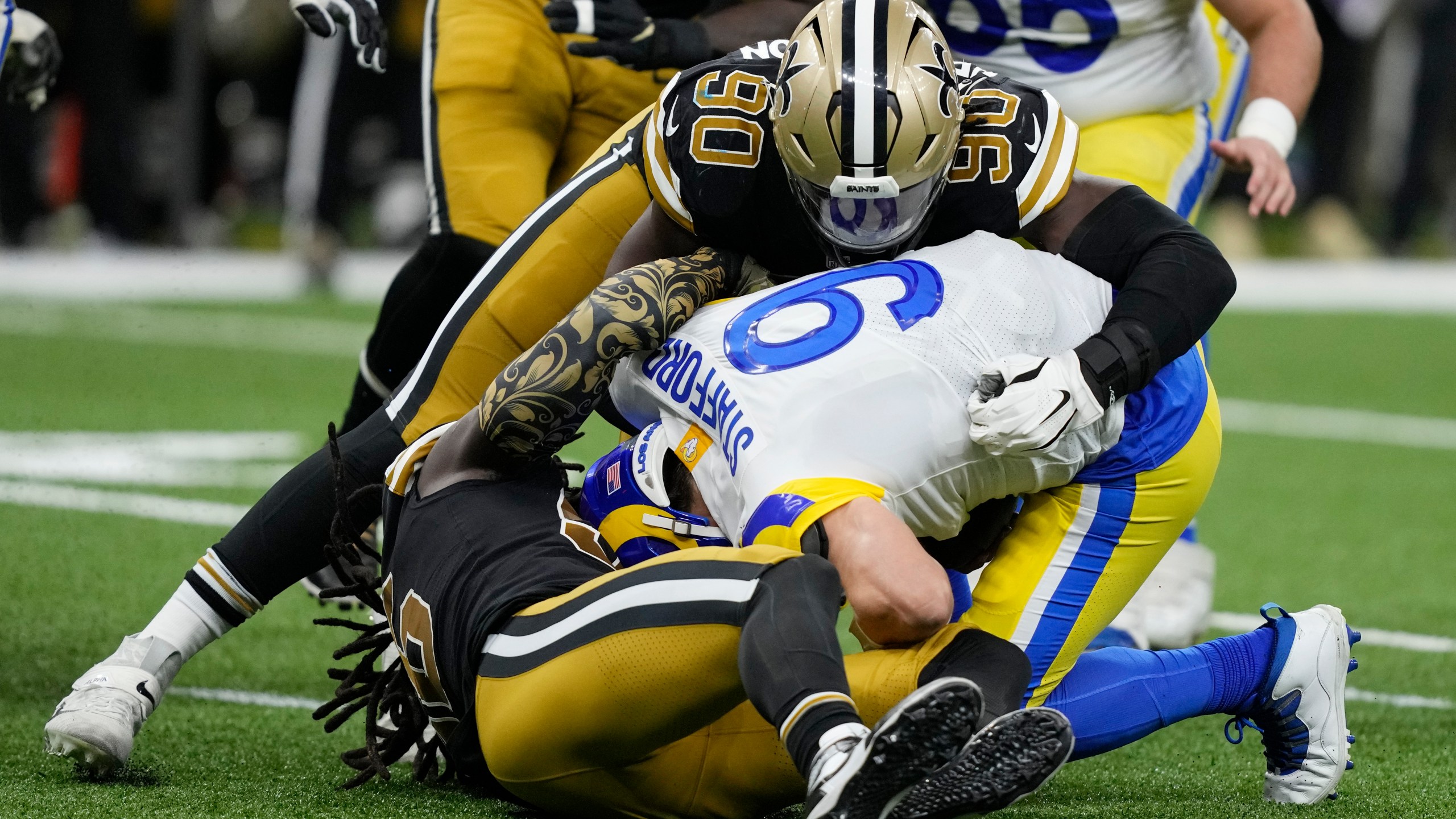 Los Angeles Rams quarterback Matthew Stafford is sacked by New Orleans Saints defensive end Tanoh Kpassagnon in the second half of an NFL football game in New Orleans, Sunday, Nov. 20, 2022. (AP Photo/Gerald Herbert)