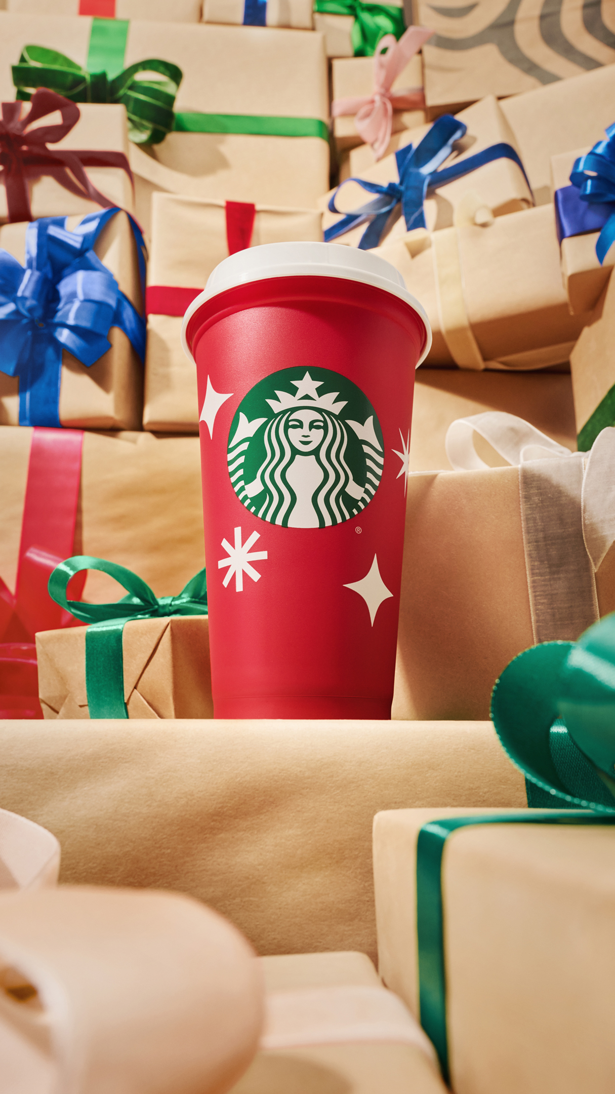 This year’s reusable red cups feature white starbursts and snowflakes for Nov. 17, 2022 in a photo provided by Starbucks.