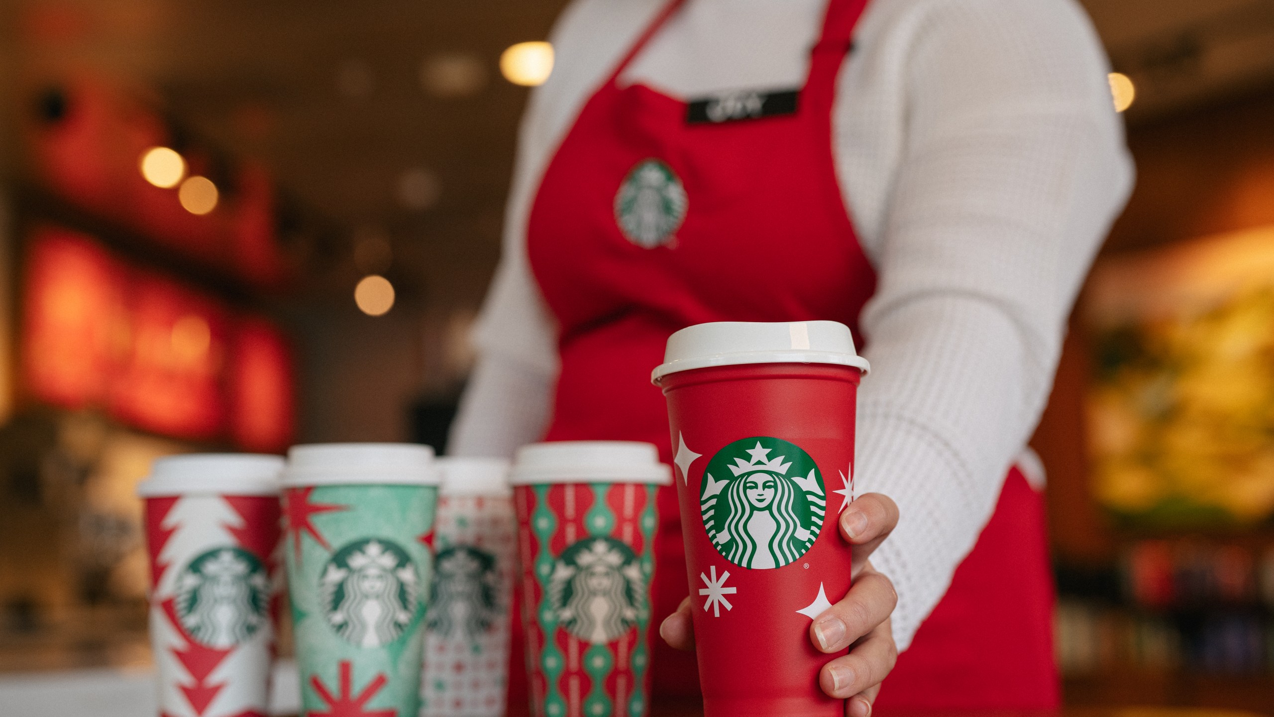 This year’s reusable red cups feature white starbursts and snowflakes for Nov. 17, 2022 in a photo provided by Starbucks.