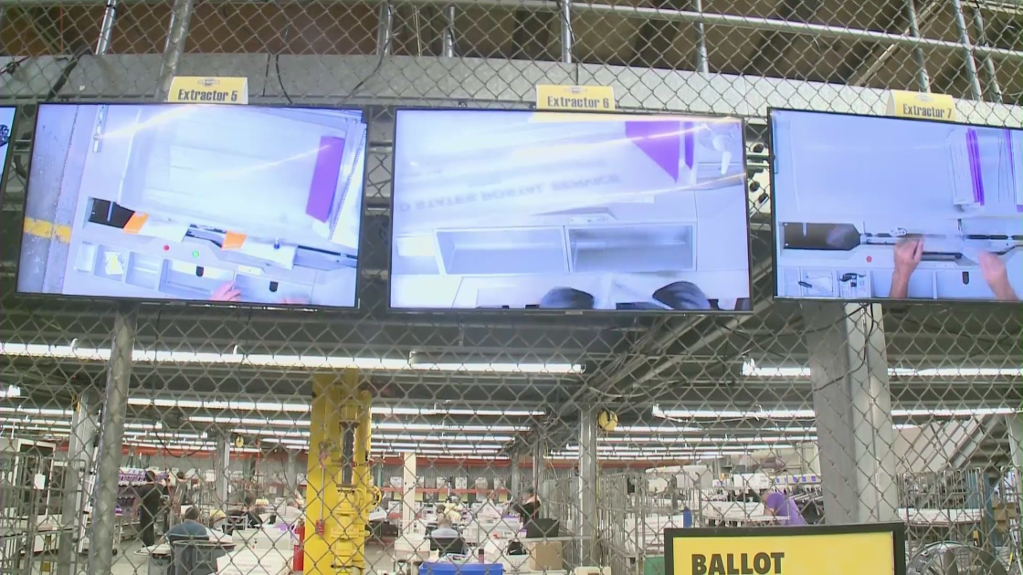 Ballot counters are monitored at the O.C. Registrar of Voters Office on Nov. 1, 2022. (KTLA)