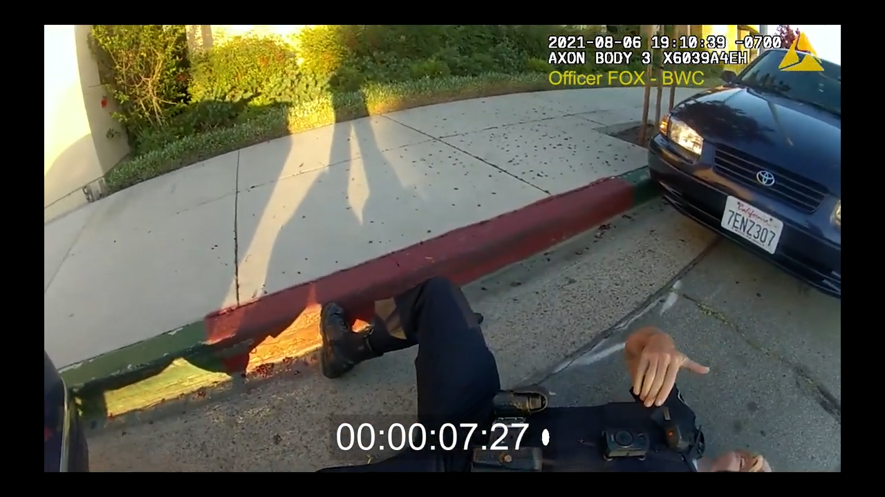 LHPD Officer Mark Milward seen on the ground after being shot by Matthew-Tuan Anh Tran outside the La Habra Police Station on Aug. 6, 2021 (LHPD)