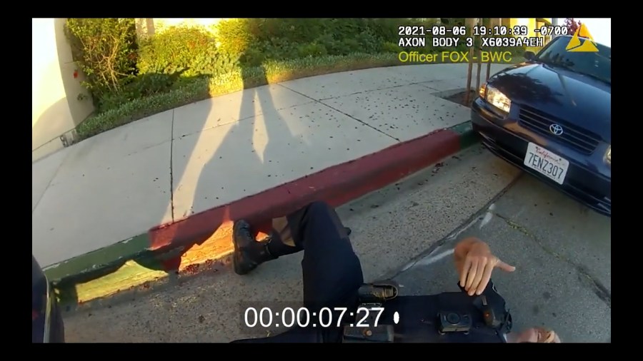 LHPD Officer Mark Milward seen on the ground after being shot by Matthew-Tuan Anh Tran outside the La Habra Police Station on Aug. 6, 2021 (LHPD)