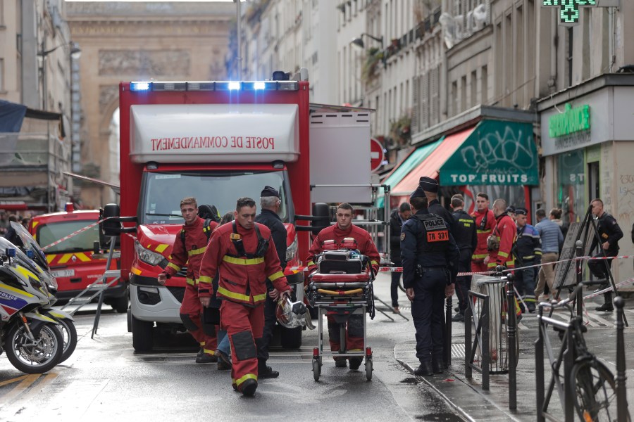 Fire brigade medics work on the scene where a shooting took place in Paris, Friday, Dec. 23, 2022. aMultiple people have been wounded and one person arrested after a shooting in central Paris on Friday, authorities said. Police cordoned off the area in the 10th arrondissement of Paris and the Paris police department warned people to stay away from the area. It said one person was arrested, without providing details. (AP Photo/Lewis Joly)