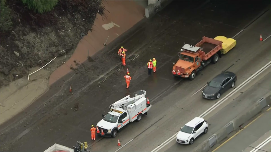 Caltrans crews work to clean up the side of the northbound 5 Freeway in Sun Valley on Jan. 10, 2023. (KTLA)