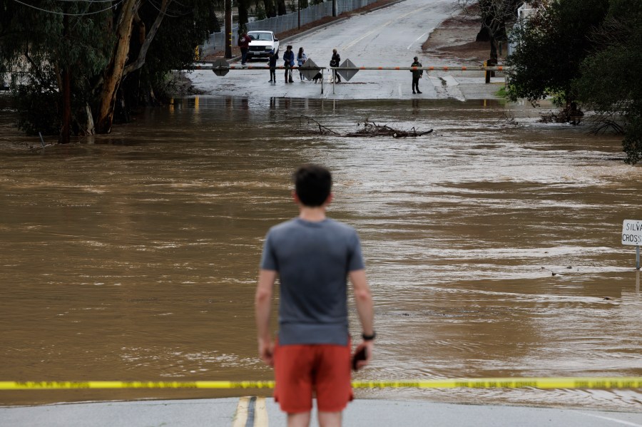 Uvas Creek floods a section of Miller Avenue in Gilroy, Calif., as the latest series of atmospheric rivers hit the Bay Area on Jan. 9, 2023. (Dai Sugano/Bay Area News Group via AP)