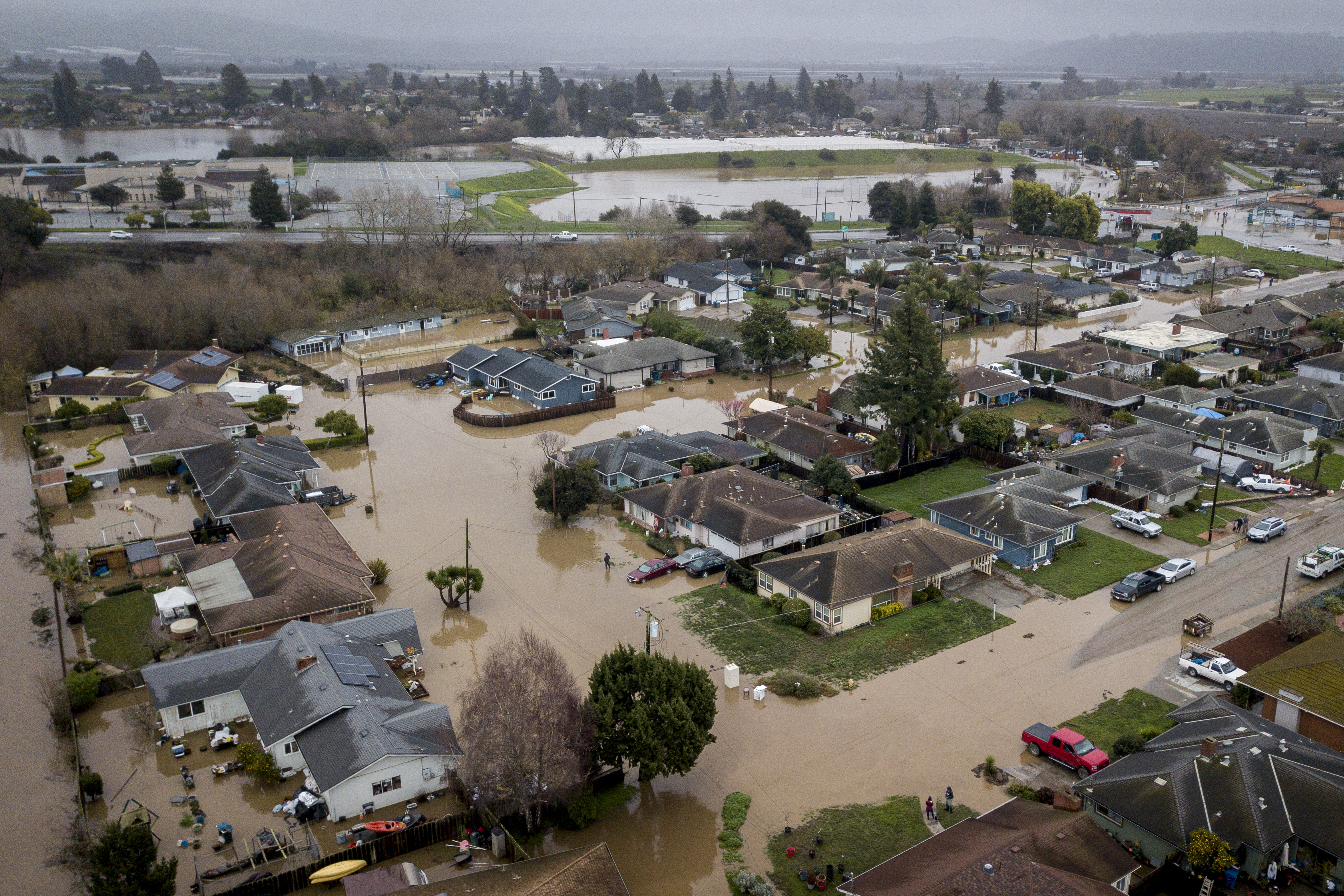 Flooding from huge amounts of rain are seen in a neighborhood off of Holohan Road near Watsonville, Calif. on Monday, Jan. 9, 2023.(Brontë Wittpenn/San Francisco Chronicle via AP)