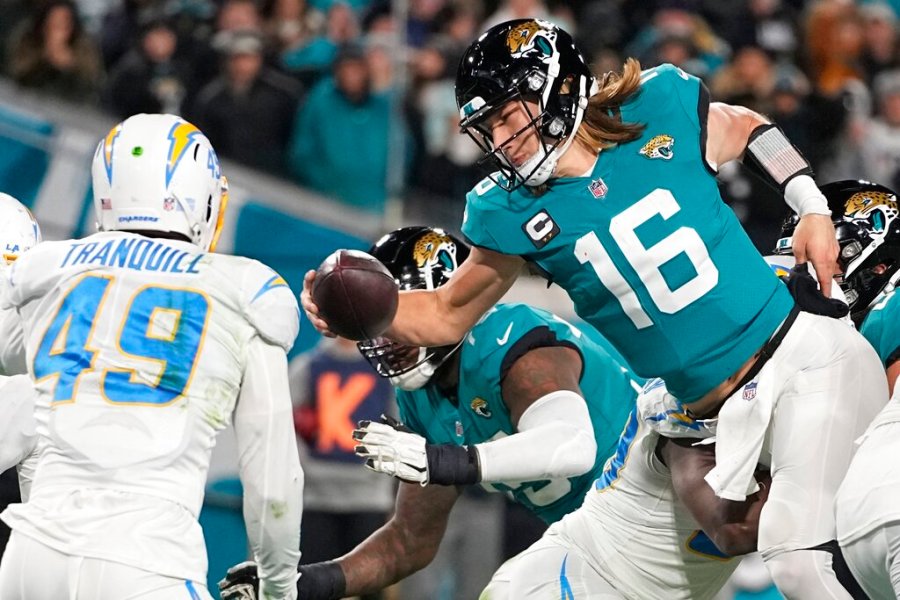 Jacksonville Jaguars quarterback Trevor Lawrence (16) leaps for a two-point conversion against the Los Angeles Chargers during the second half of an NFL wild-card football game, Saturday, Jan. 14, 2023, in Jacksonville, Florida.