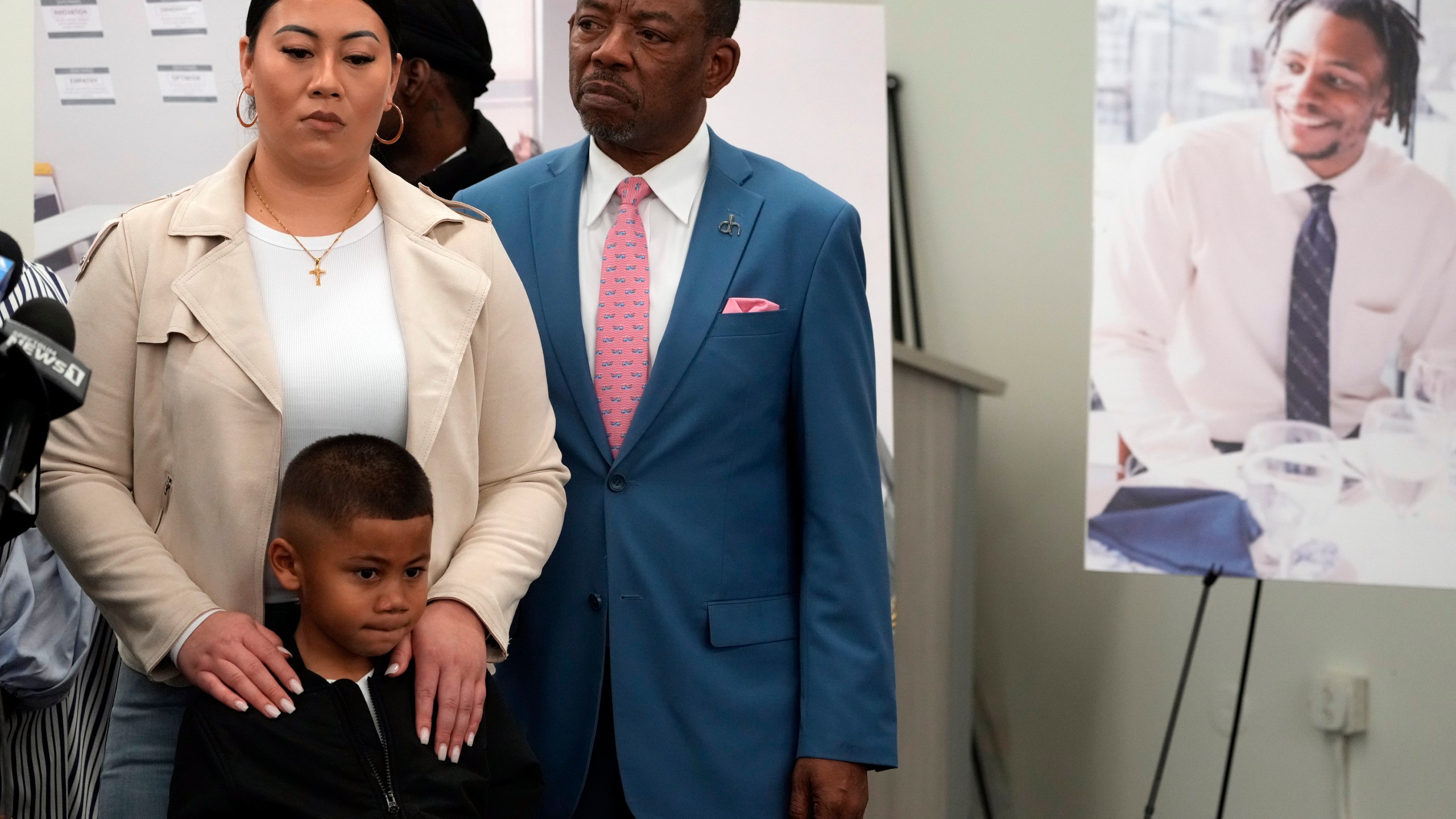 Lawyer Carl Douglas, right, holds a news conference with Gabrielle Hansel, guardian of five-year-old Syncere Kai Anderson, to announce filing a $50 million in damages claim against the city of Los Angeles over the death of Keenan Anderson, seen photo right, at a news conference in Los Angeles on Jan. 20, 2023. (Damian Dovarganes/Associated Press)