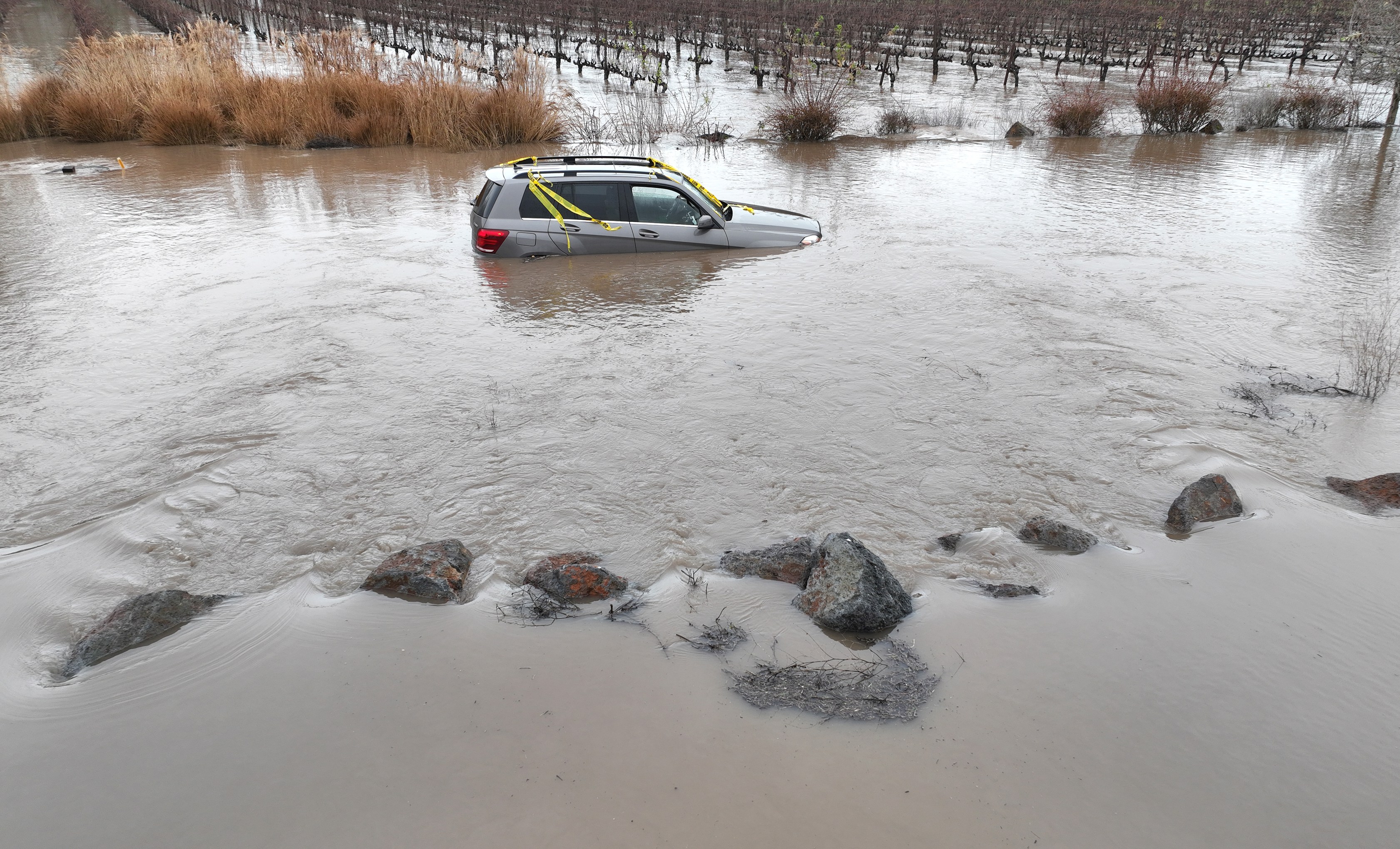 In an aerial view, a car is submerged in floodwater after heavy rain moved through the area on Jan. 9, 2023 in Windsor, California. Justin Sullivan/Getty Images)