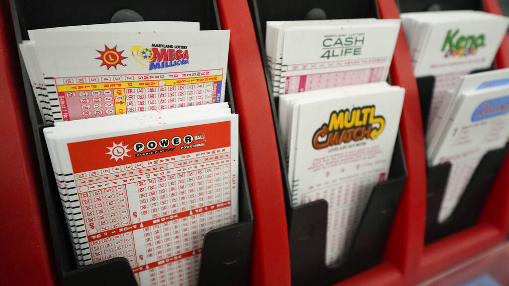 Play stubs for lottery games are displayed on the counter at a Maryland liquor store in early January. (Julio Cortez/Associated Press)