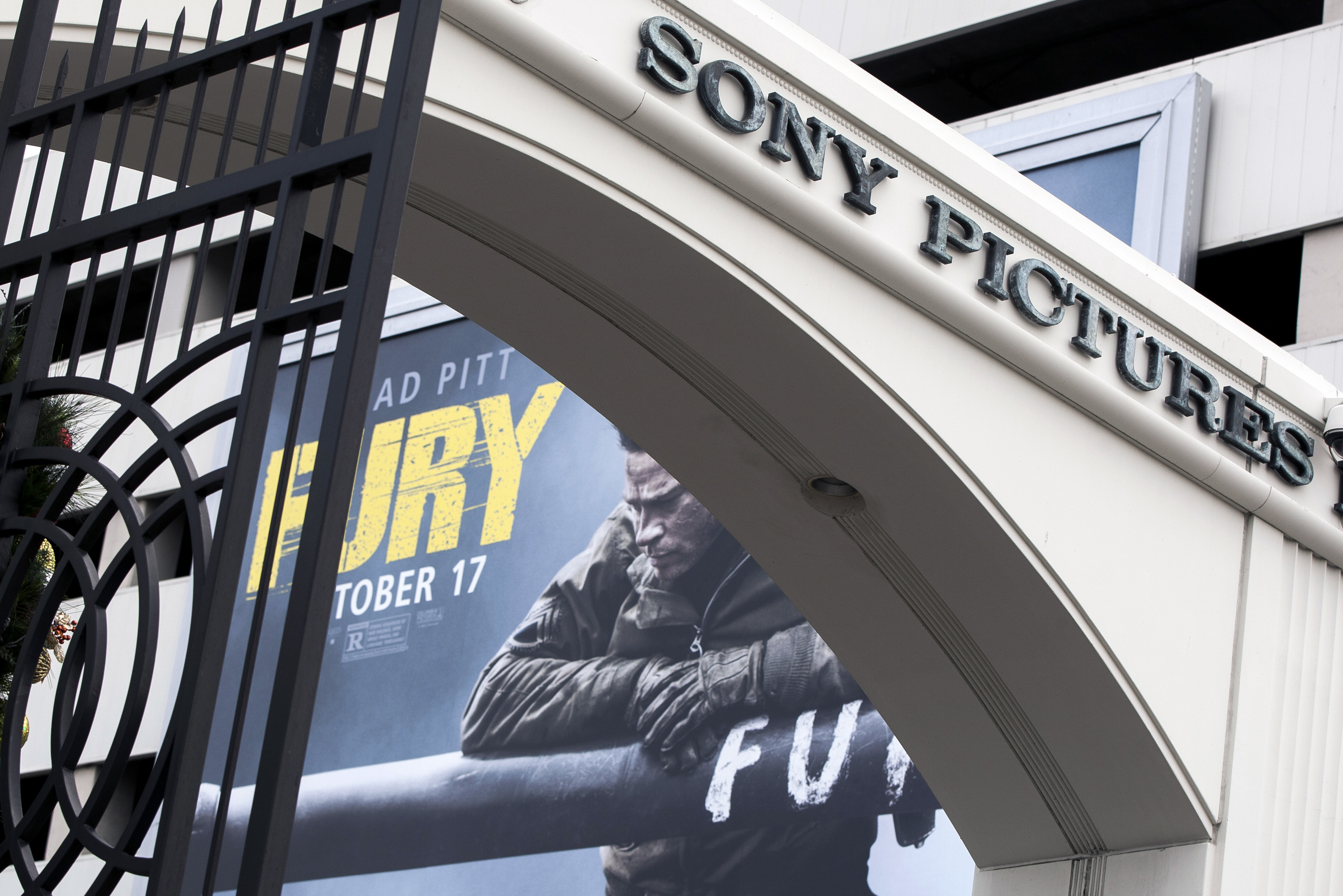 In this Dec. 18, 2014, file photo, a movie billboard is displayed behind a Sony Pictures Entertainment Studio entrance in Culver City. (AP Photo/Damian Dovarganes, File)