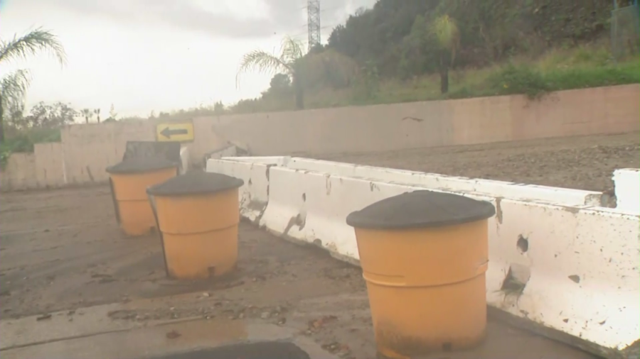 Mud seeps through K-rails set up in the Mel Canyon area of Duarte on Jan. 10, 2023. (KTLA)  