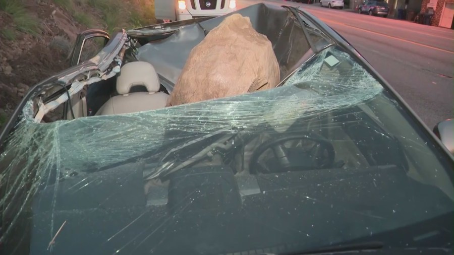 The aftermath of a giant boulder crushing a car as it tumbled off a Malibu hillside on Jan. 10, 2023. (KTLA)