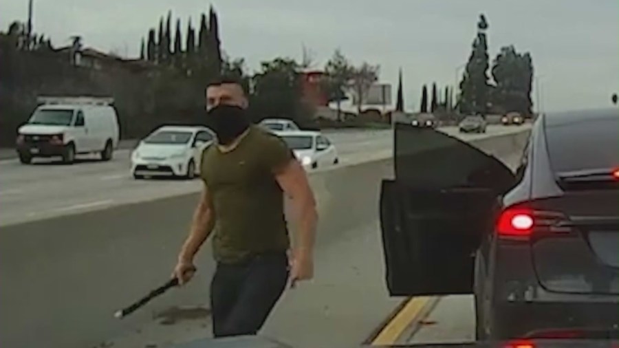 Suspect seen getting out of a Tesla SUV and attacking a victim with a large pipe on a SoCal freeway.