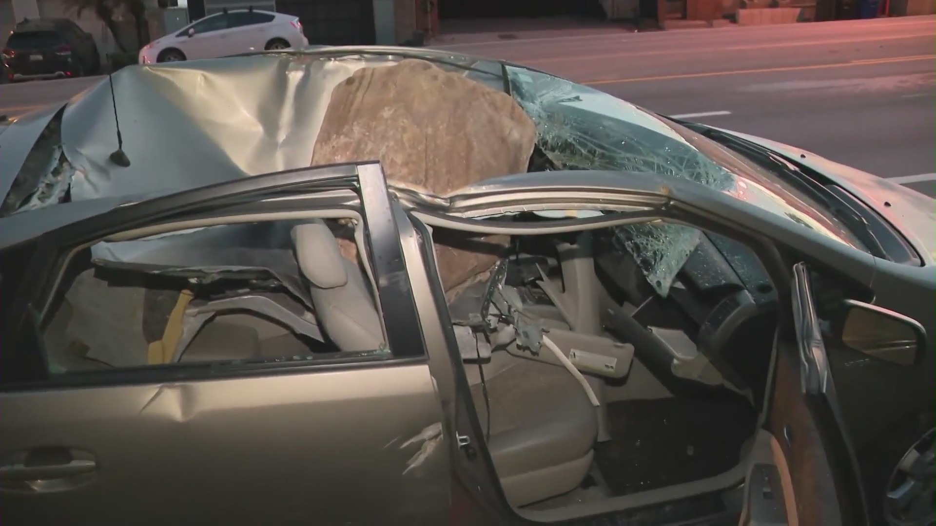 The aftermath of a giant boulder crushing a car as it tumbled off a Malibu hillside on Jan. 10, 2023. (KTLA)