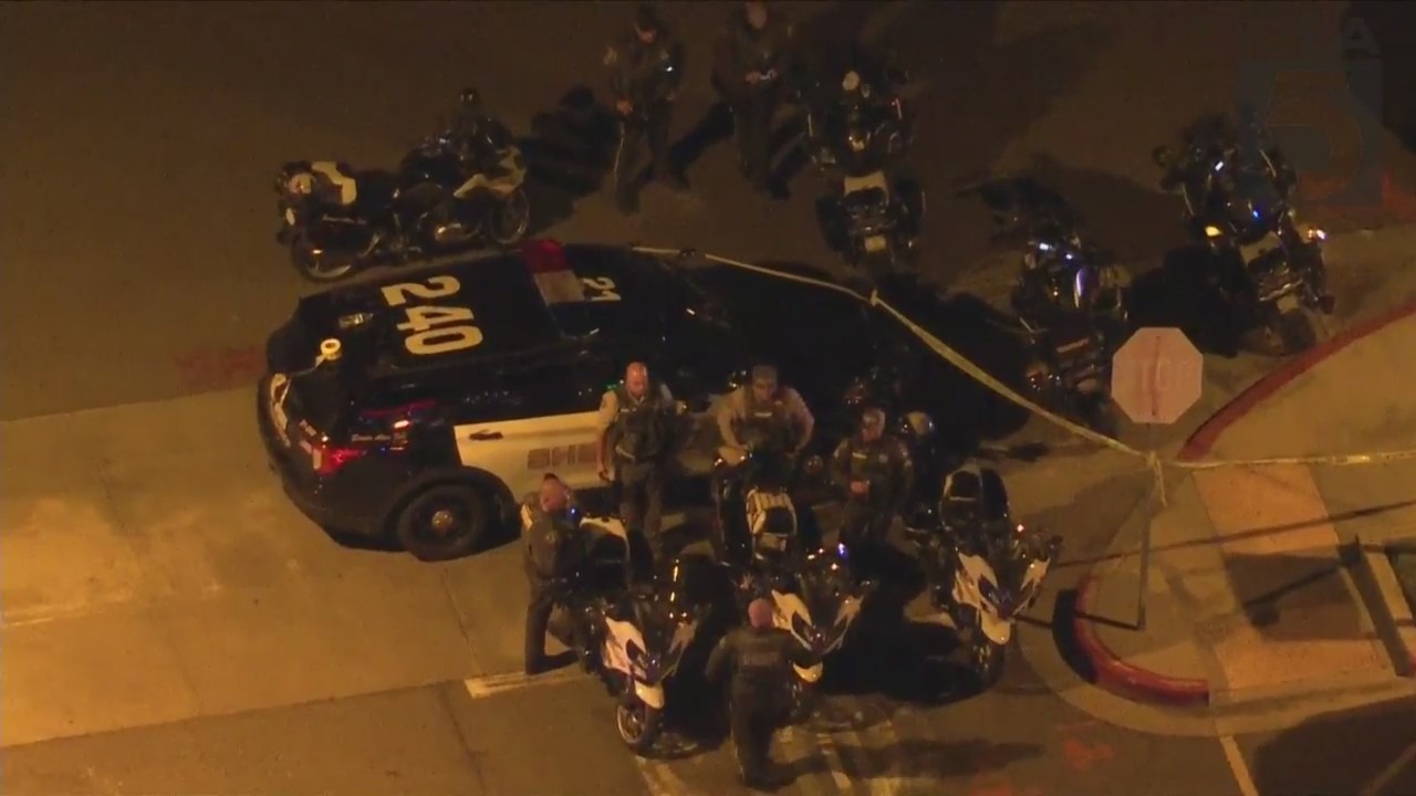 Authorities outside hospital where Riverside County Sheriff's Deputy was taken after being shot in Lake Elsinore on Jan. 13, 2023. (KTLA)