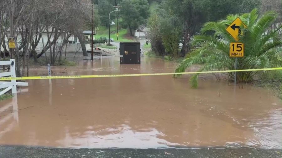 A UPS delivery van got stuck on a low-lying flooded street in Ventura on Jan. 9, 2023. (KTLA)