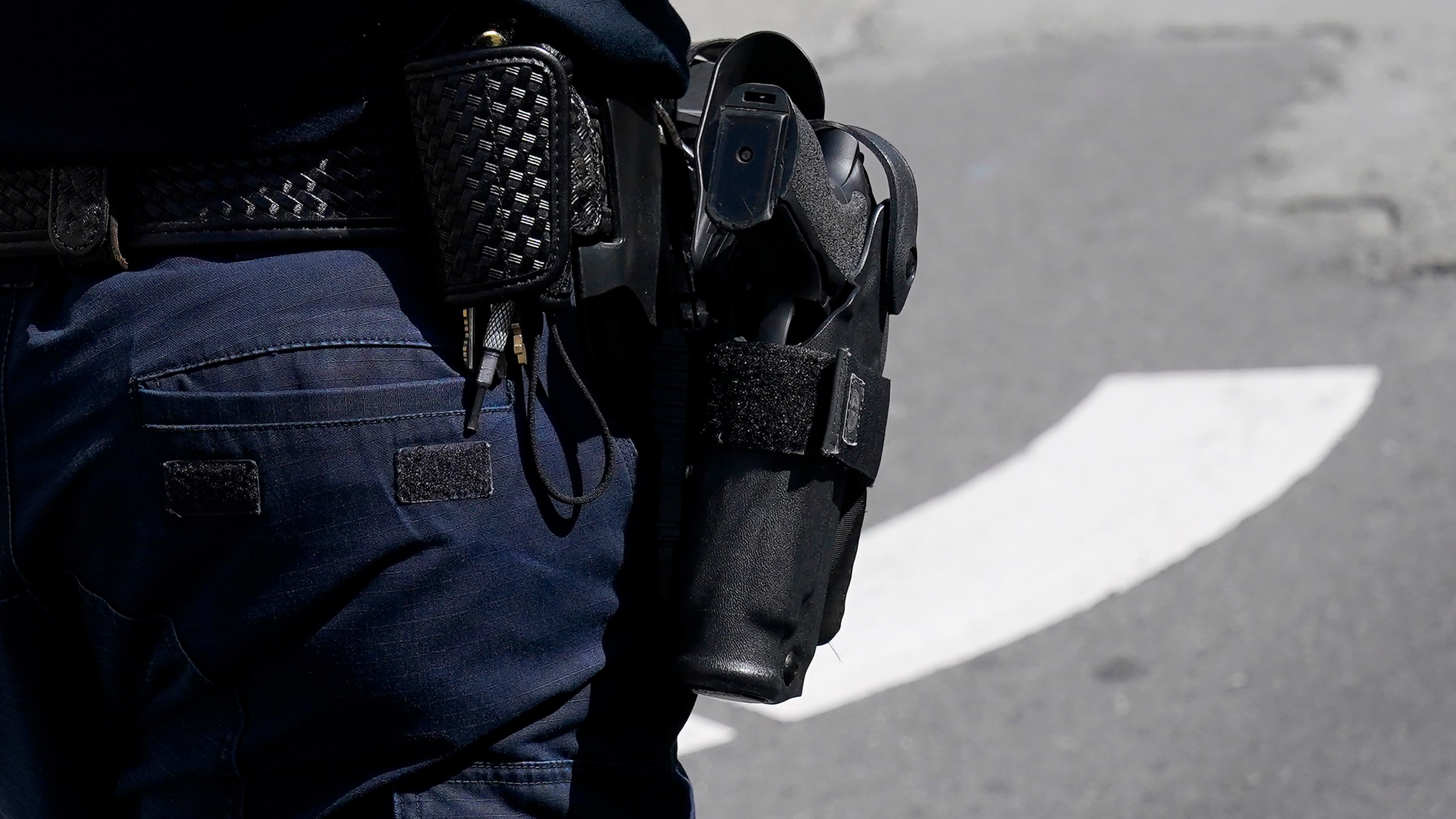 A gun in a holster is shown worn by a San Francisco Police officer in San Francisco, Saturday, March 13, 2021. (AP Photo/Jeff Chiu)