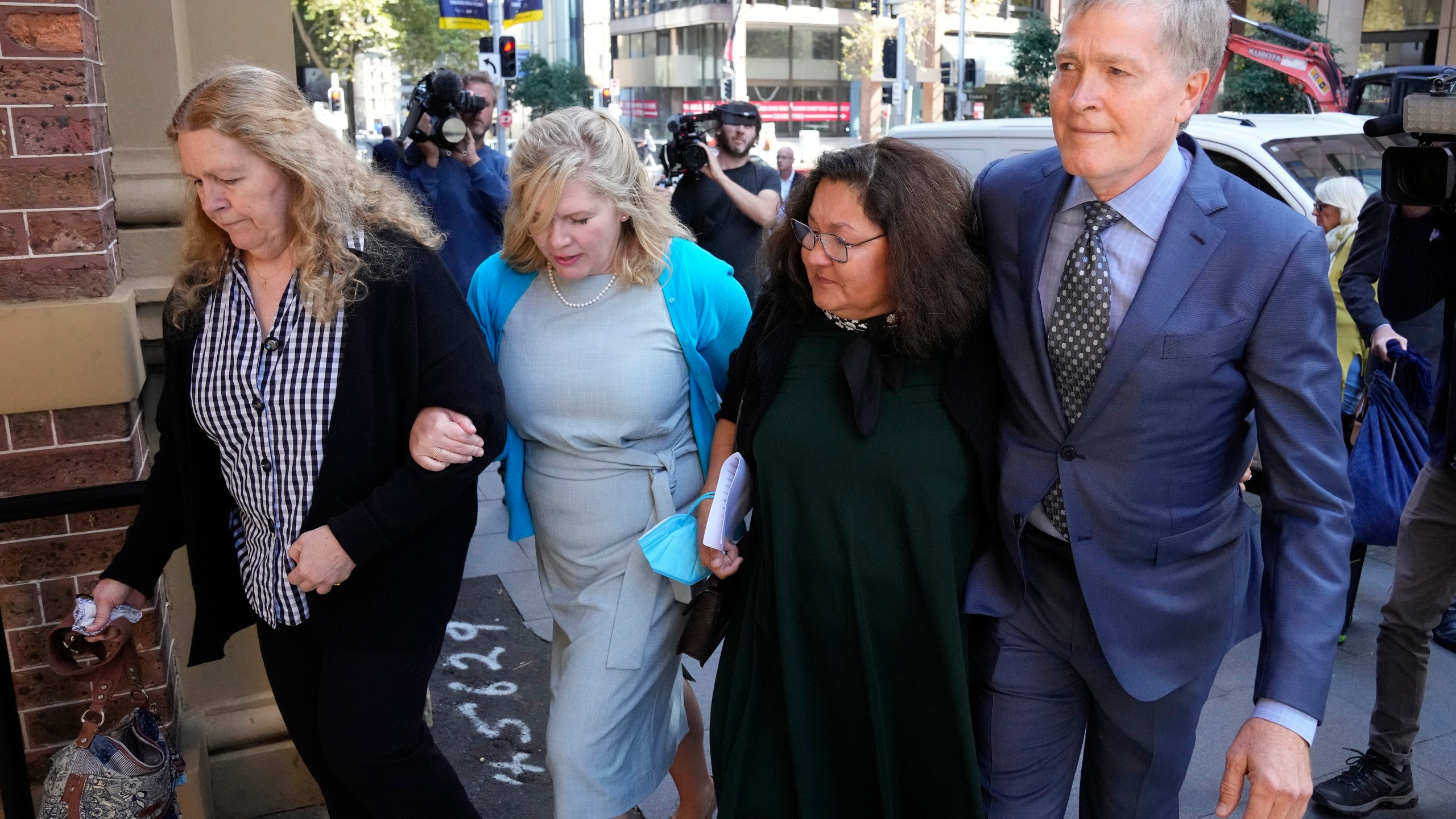 Steve Johnson, right, with his sisters, Terry, left, and Rebecca and his wife Rosemarie, second right, arrive at the Supreme Court in Sydney on May 2, 2022, for a sentencing hearing in the murder of Scott Johnson, Steve, Terry and Rebecca's brother. An Australian pleaded guilty on Thursday, Feb. 23, 2023, to the manslaughter of an American Scott Johnson, who fell to his death 35 years ago from a Sydney cliff top that was known as a gay meeting place. (AP Photo/Rick Rycroft, File)