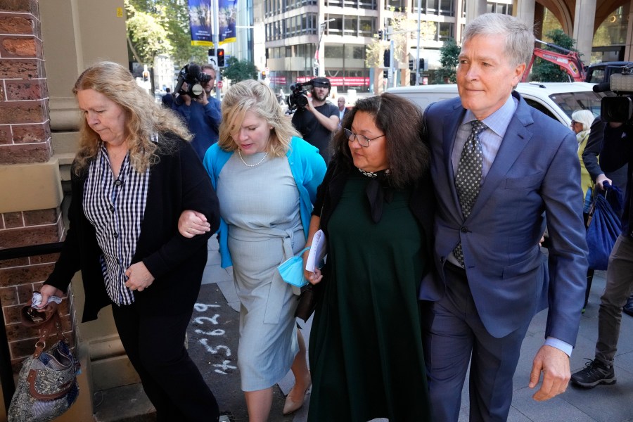 Steve Johnson, right, with his sisters, Terry, left, and Rebecca and his wife Rosemarie, second right, arrive at the Supreme Court in Sydney on May 2, 2022, for a sentencing hearing in the murder of Scott Johnson, Steve, Terry and Rebecca's brother. An Australian pleaded guilty on Thursday, Feb. 23, 2023, to the manslaughter of an American Scott Johnson, who fell to his death 35 years ago from a Sydney cliff top that was known as a gay meeting place. (AP Photo/Rick Rycroft, File)