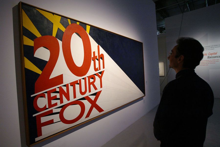 A person looks at Edward Ruscha's "Large trademark with eight spotlights" (1962) exposed in the exhibition "Los Angeles 1955-1985, naissance d'une capitale artistique" (the birth of an artistic capital) on March 3, 2006. (MEHDI FEDOUACH/AFP via Getty Images)