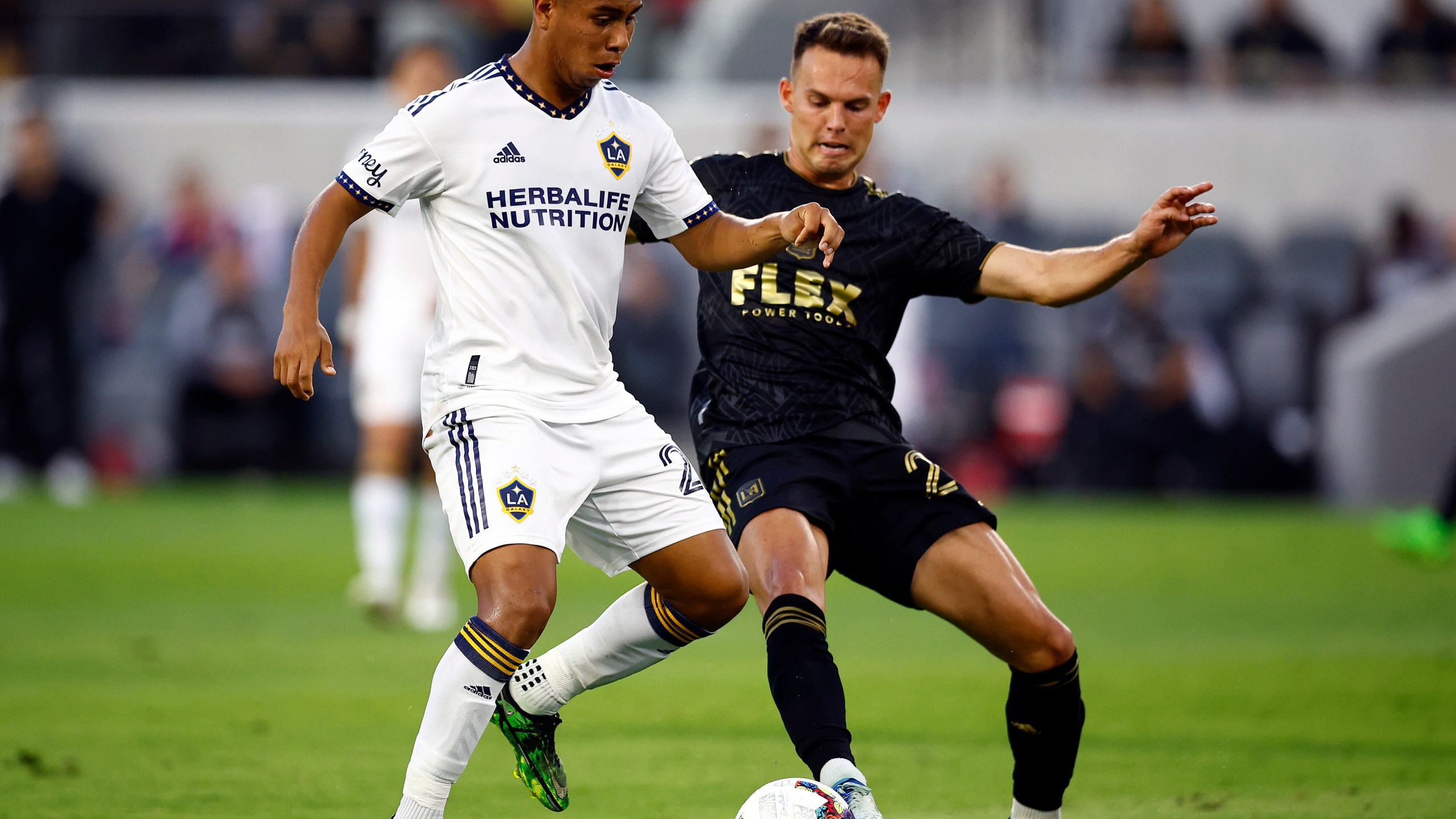 Efrain Alvarez #26 of Los Angeles Galaxy controls the ball against Danny Musovski #29 of Los Angeles FC in the first half at Banc of California Stadium on July 8, 2022 in Los Angeles. (Ronald Martinez/Getty Images)