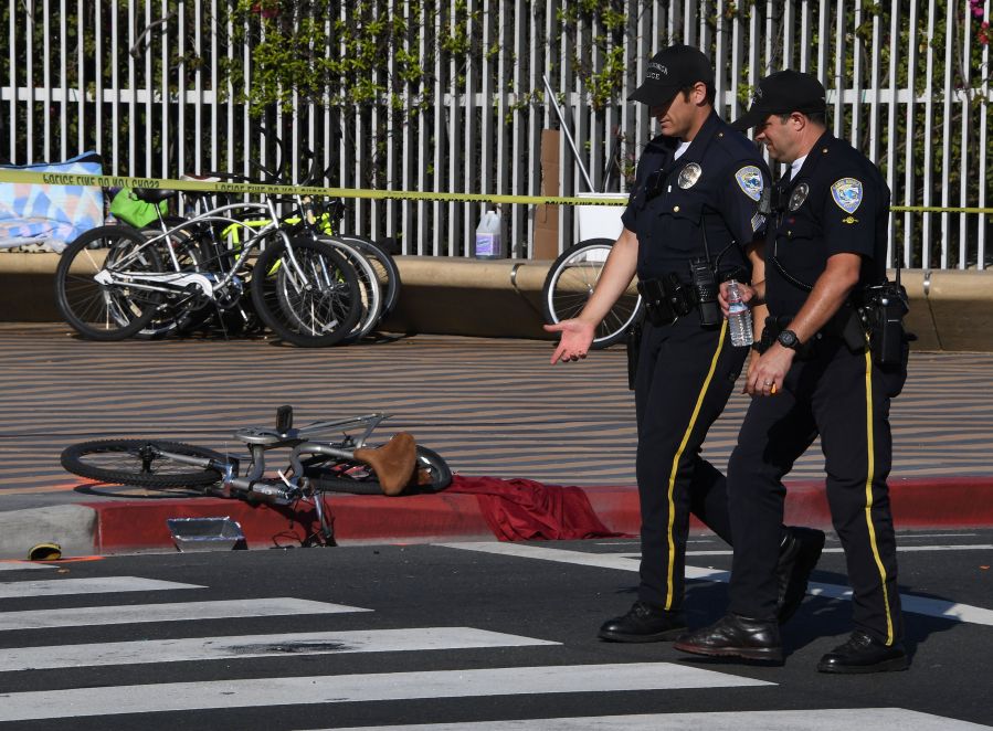 Police walk past a damaged bike at the scene of an six car accident after an elderly woman driver severly injured a cyclist and collided with the other vehicles at the entrance to the historic Santa Monica Pier in Santa Monica, California on April 19, 2017. (MARK RALSTON/AFP via Getty Images)