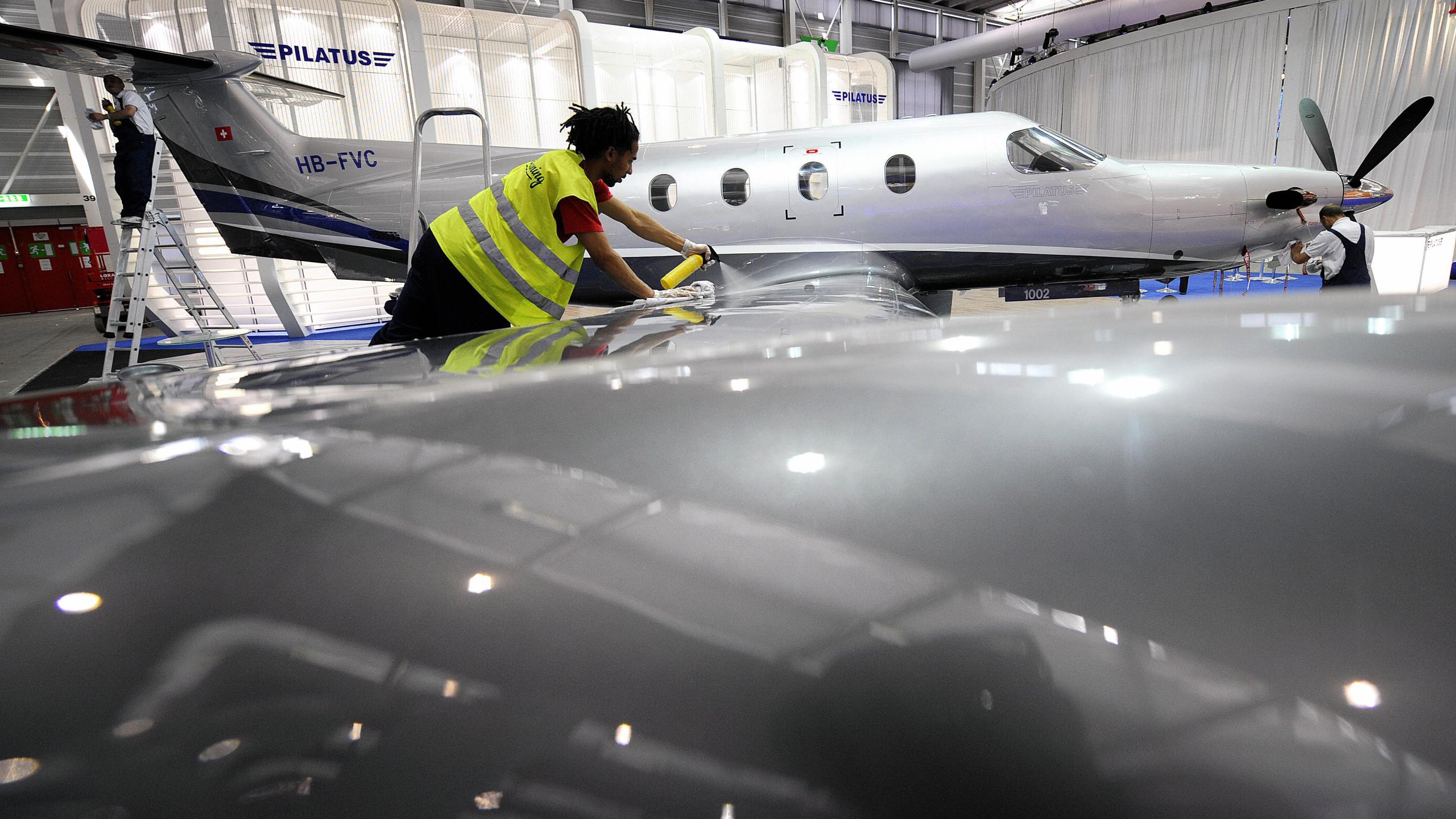 An employee cleans a PC-12 model of the Swiss aircraft manufacturer Pilatus during the press day of the 8th Annual European Business Aviation Convention & Exhibition on May 19, 2008, in Geneva's International Airport. (Fabrice Coffrini/AFP via Getty Images)